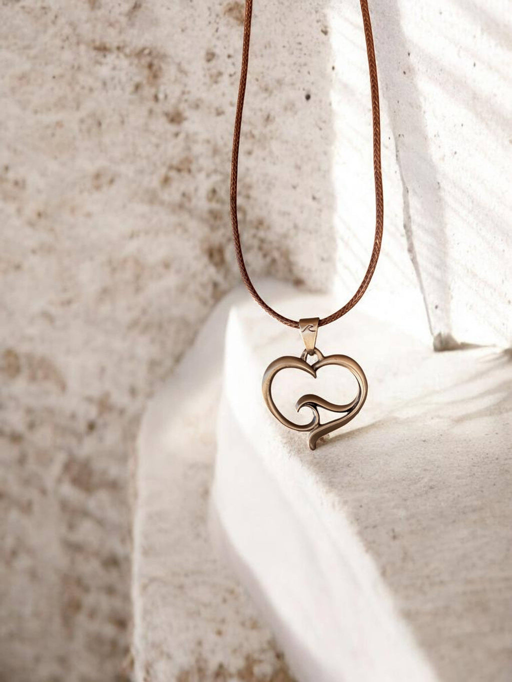 Roland St John ocean wave heart bronze pendant close-up