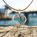 Roland St John ocean wave heart bronze pendant on 18-inch cord
